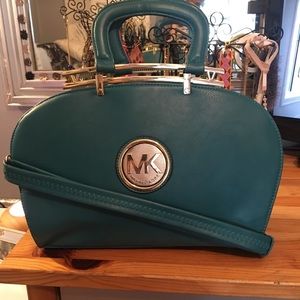 Blue satchel with gold medallion center